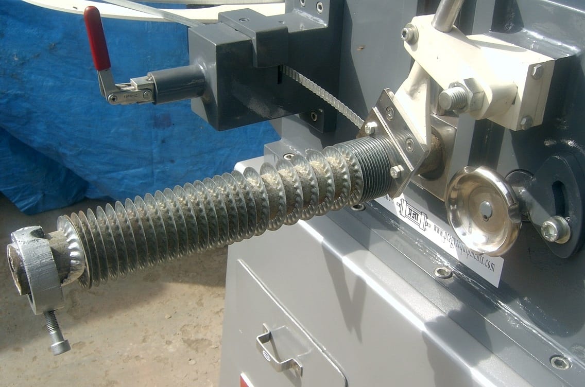 Fin tube machine showing the fin forming mechanism and tube feeding system